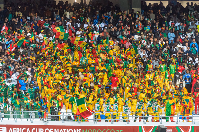 African football fans waving red, green and yellow flags at the Africa Cup of Nations in Morocco