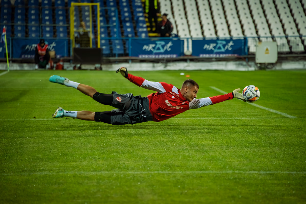 A goalkeeper diving to make a save during a match