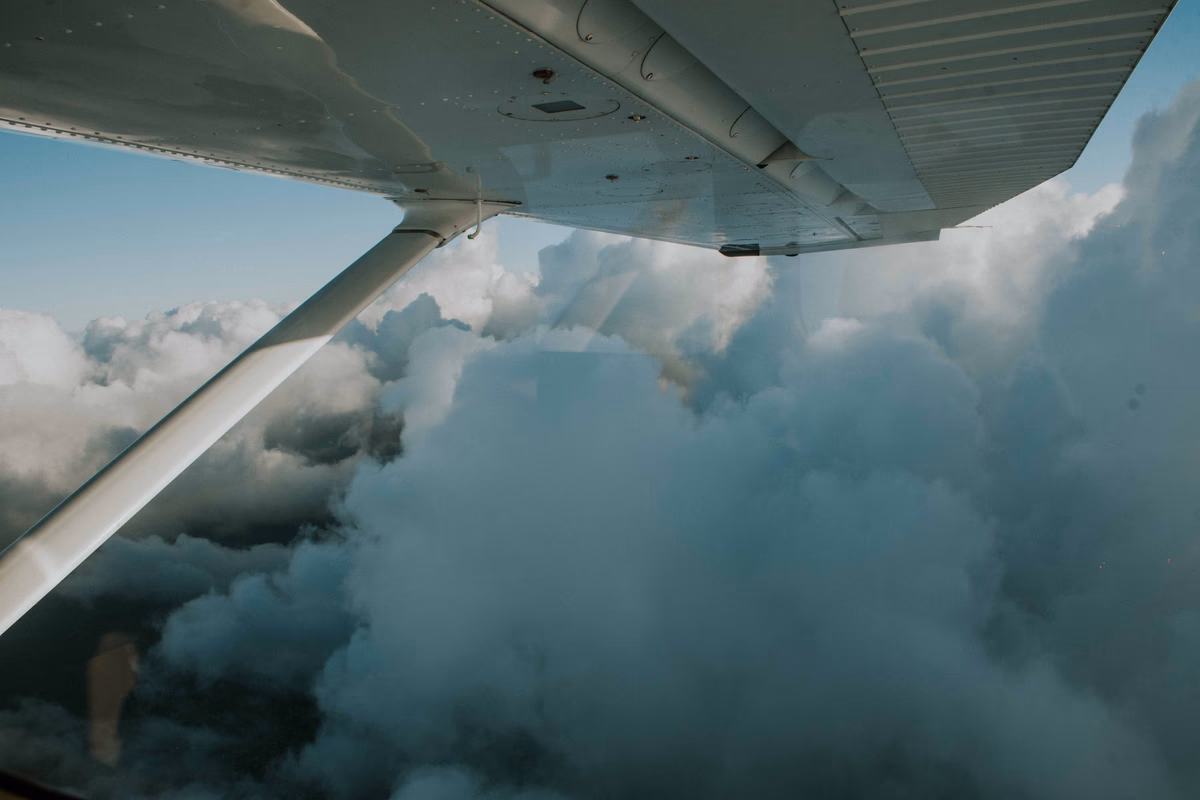 View over an aircraft wing above the clouds in flight